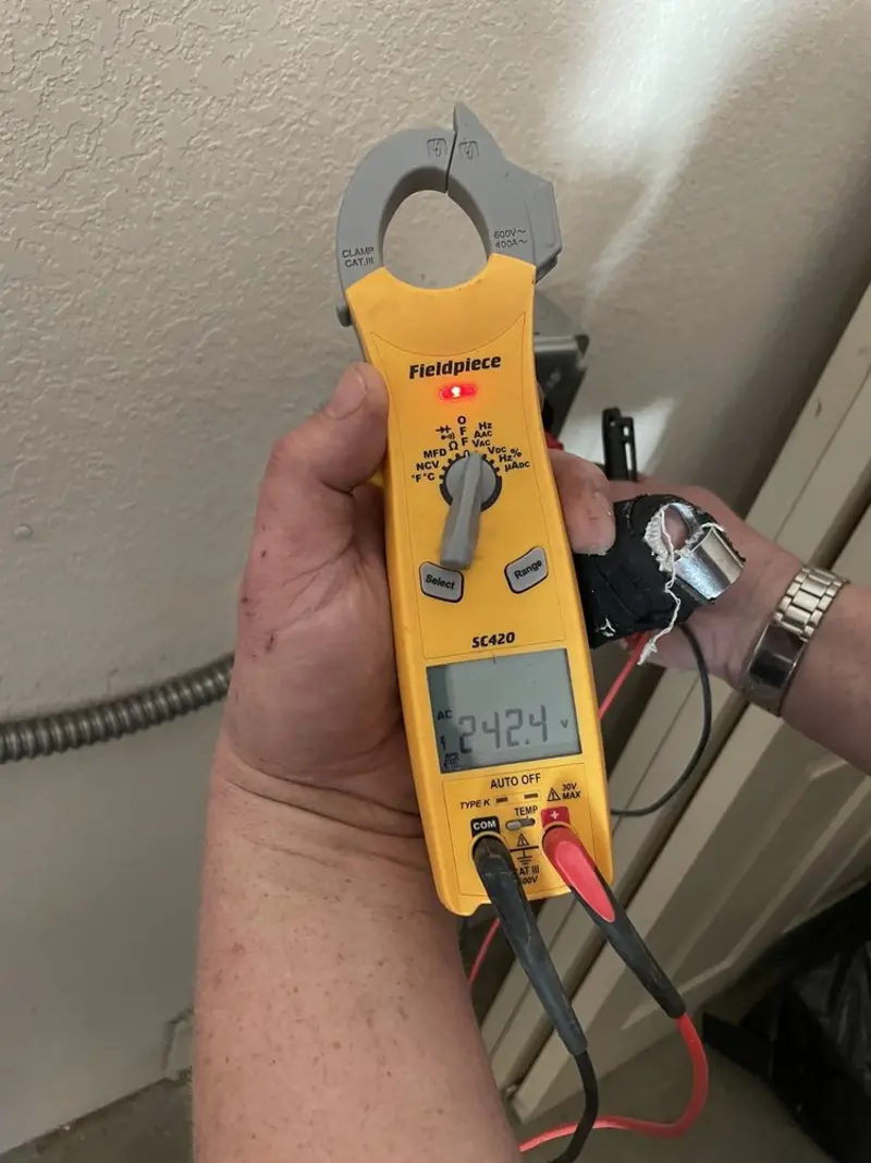 Voltage testing with clamp meter during Outlet Installation in Fredericksburg
